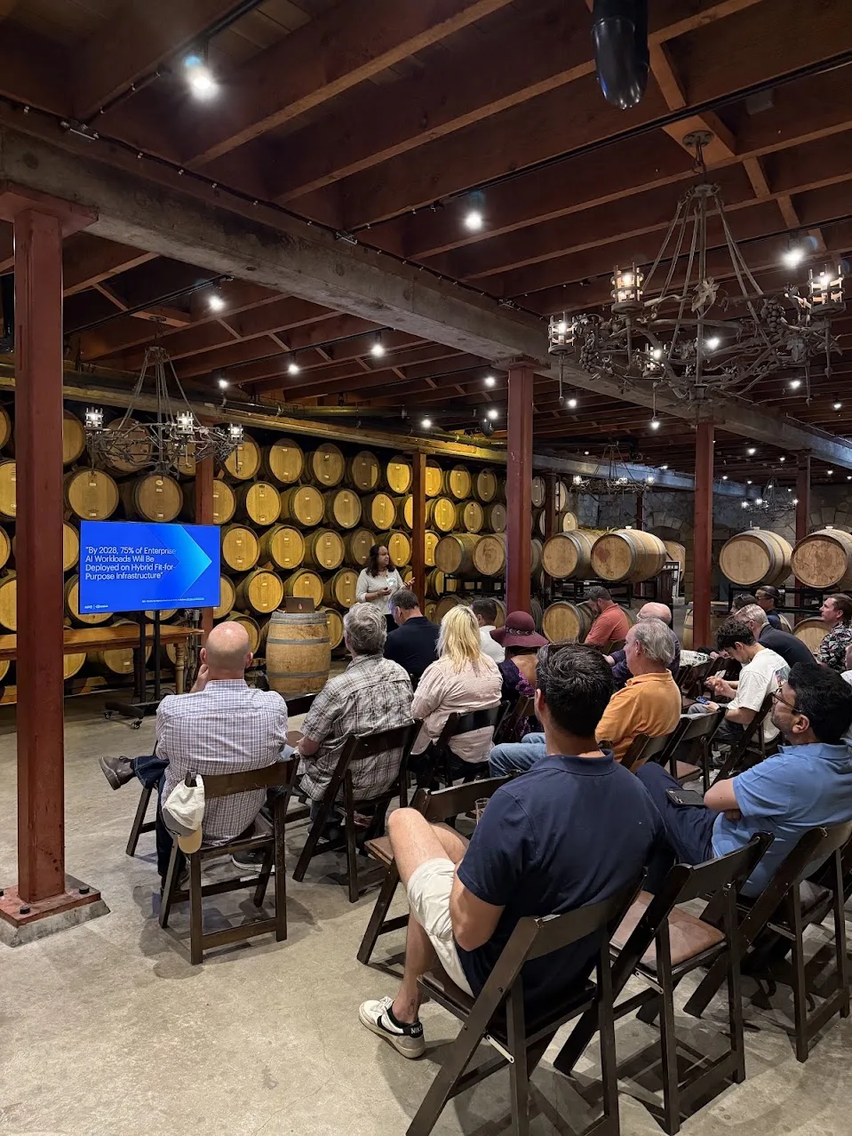 A presentation in a winery barrel room